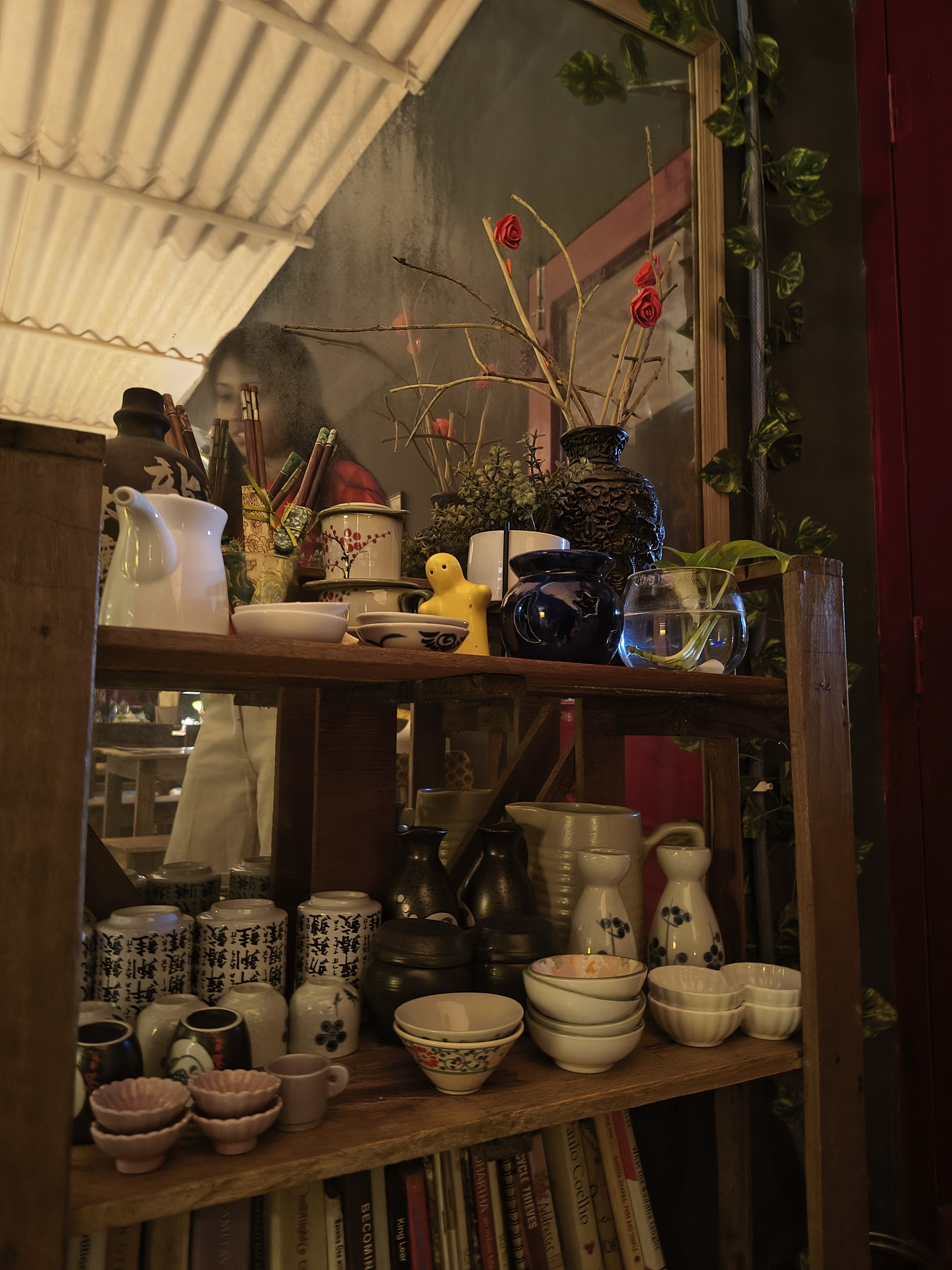 Books and Japanese crockery on shelves